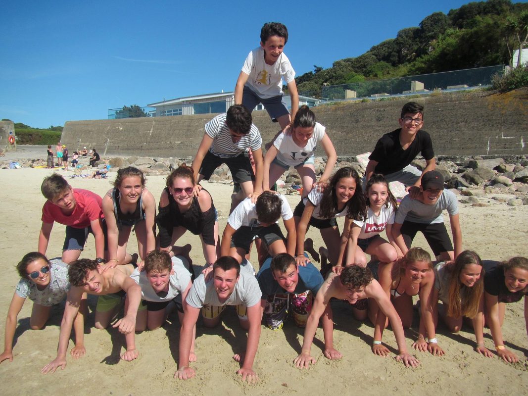 English Students making a Pyramid on the beach