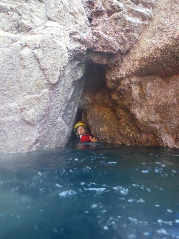 Student coming out of a cave with JLA