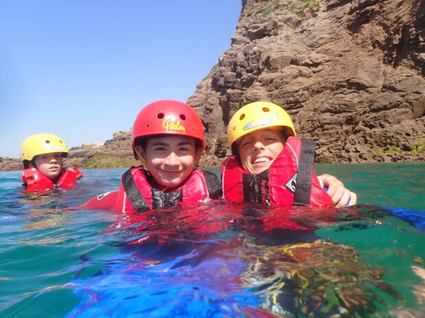 Two English Students in the water enjoying coasteering in full equipment